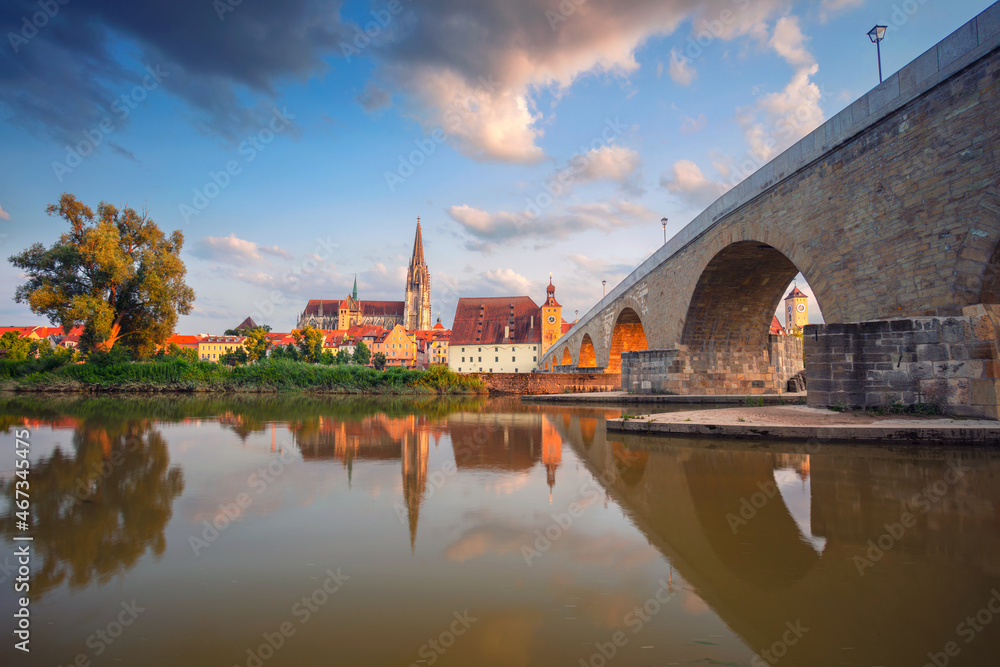 Regensburg, Germany. Cityscape image of Regensburg, Germany with Old Stone Bridge over Danube River and St. Peter Cathedral at summer sunset.