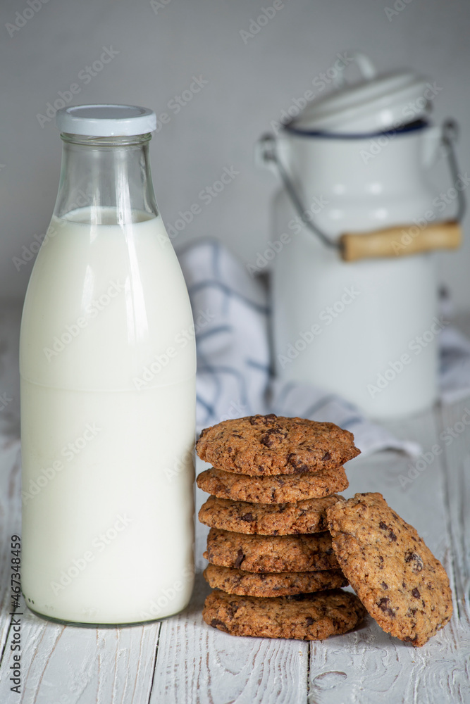 chocolate coockies next to a bottle of fresh milk. selective focus. handmade holiday biscuits chocolate coockies next to a bottle of fresh milk. selective focus. handmade holiday biscuits