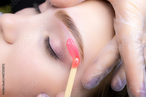 Fotografie close-up of applying red wax to remove unwanted hairs from the lower contour of