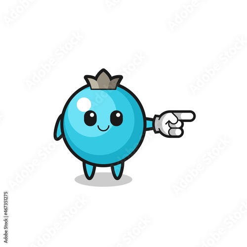 blueberry mascot with pointing right gesture