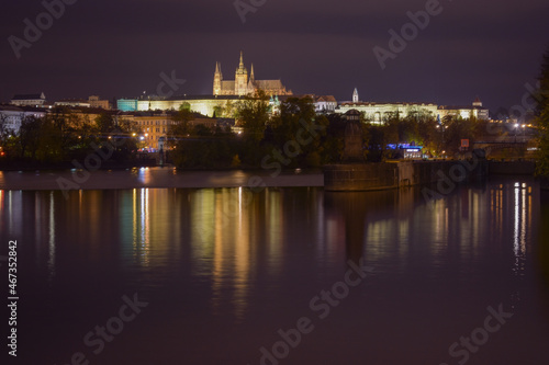 Prague Castle at night  street lights reflected in the water surface  beautiful night city