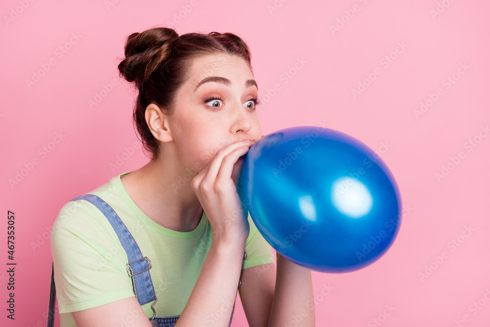 Profile photo of funky positive girl inflate balloon wear jeans overall green t-shirt isolated on pink background