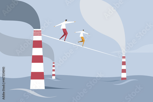 People escaping through a tight rope tied between two industrial exhaust pipes submerged in water. Concept for global warming