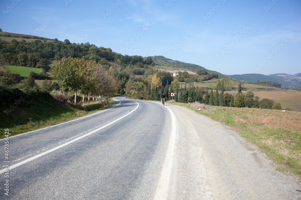 
the road behind the mountains