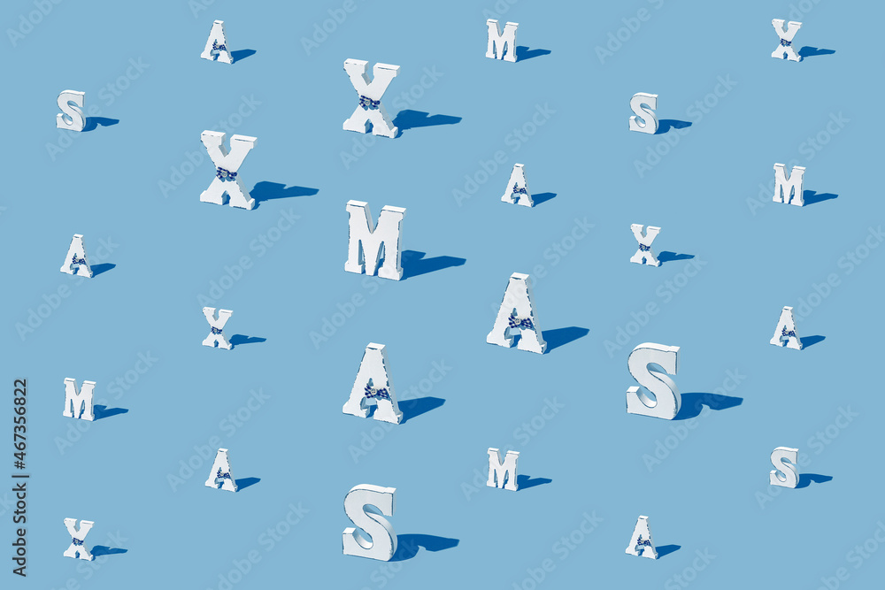 Creative pattern made of white xmas letters on blue background. Minimal style. Christmas celebration concept. Creative pattern made of white xmas letters on blue background. Minimal style. Christmas celebration concept.