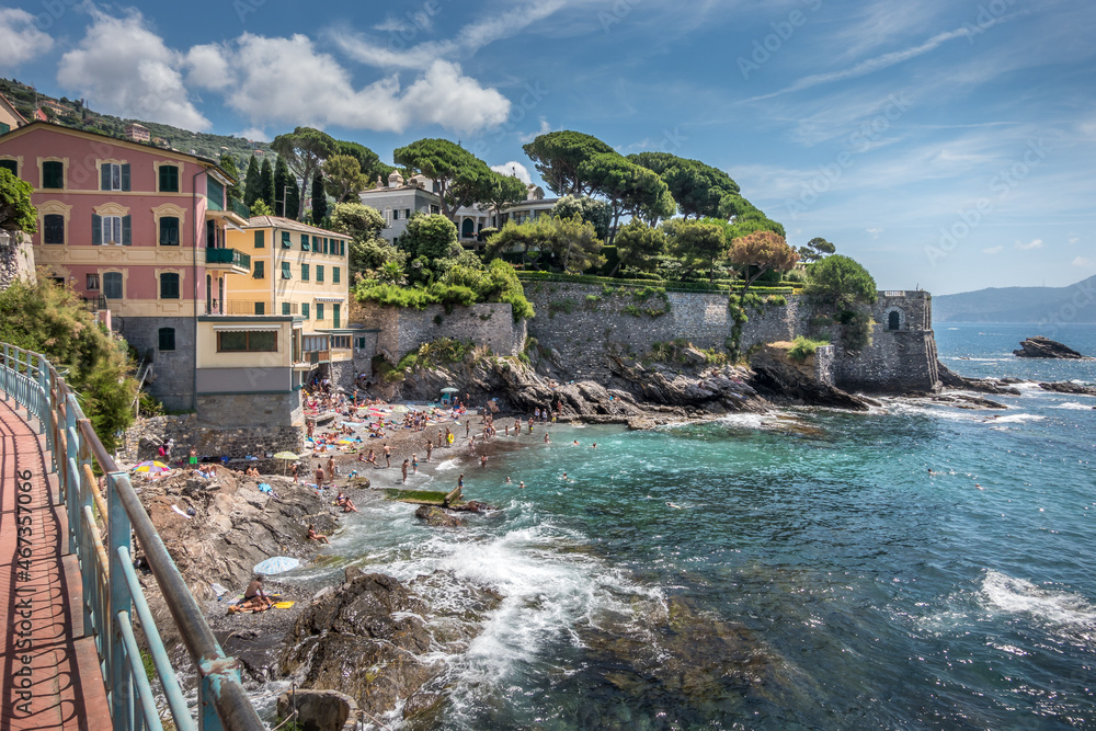 View of the beautiful promenade of Nervi in Genoa, with rocks and sand beach, Italy.