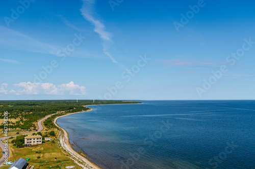 Fototapeta Naklejka Na Ścianę i Meble -  Aerial shot of the Sorve peninsula by the Baltic sea from the Sorve lighthouse in Saaremaa, Estonia. Clear blue sky, calm weather