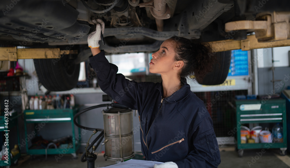 Mechanic changing engine, service car workshop automobile. professional female shop maintenance
