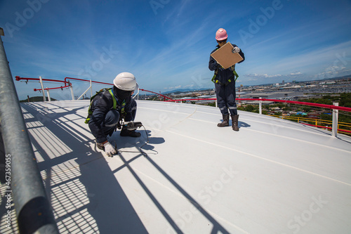 Fotografie, Tablou Male two worker are for inspection ultrasonic thickness roof plate top