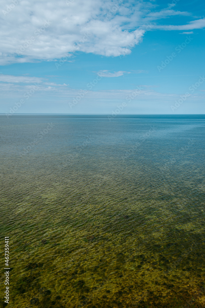 Obraz premium Aerial view over the Baltic sea from the Panga cliff in Saaremaa, Estonia during sunny day. the highest bedrock outcrop in western Estonia