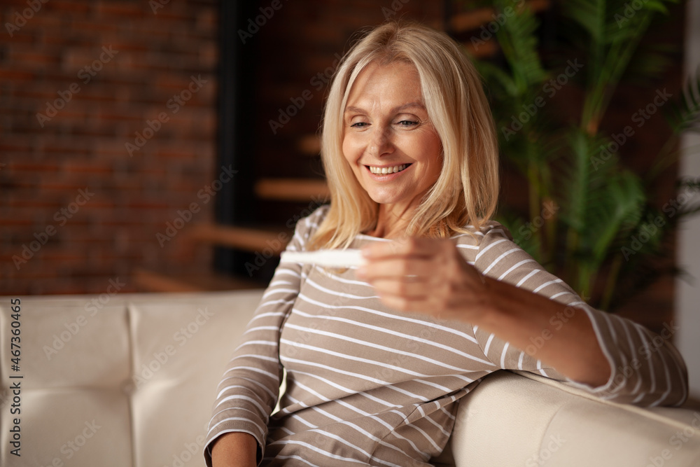 Pregnancy test in the hands of a mature woman. Late pregnancy and motherhood. Pregnancy test in the hands of a mature woman. Late pregnancy and motherhood.