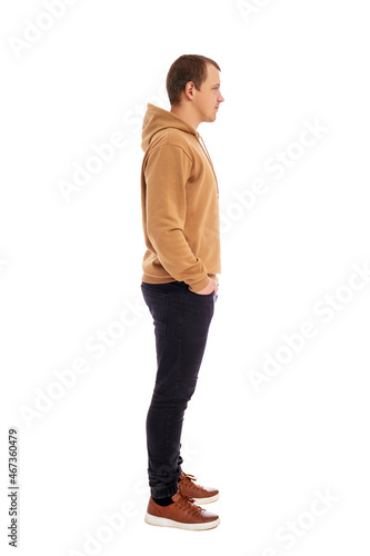 side view of handsome man in beige hoodie isolated on white