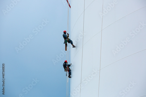 Male two workers down height tank rope access inspection of thickness shell plate storage tank gas propane