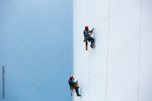 Male two workers down height tank rope access inspection of thickness shell plate storage tank gas propane