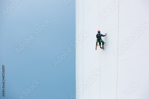 Male workers down height tank rope access inspection of thickness shell plate storage tank gas photo