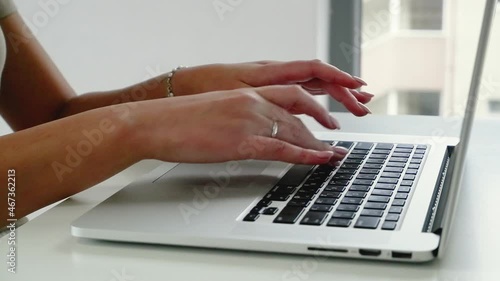 Female hands of business woman professional user worker using typing on laptop notebook keyboard sit at home office desk working online with pc software apps technology concept, close up side view
