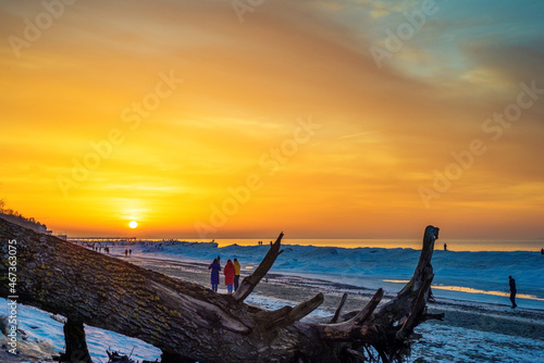 Snow and ice on the seashore at sunset