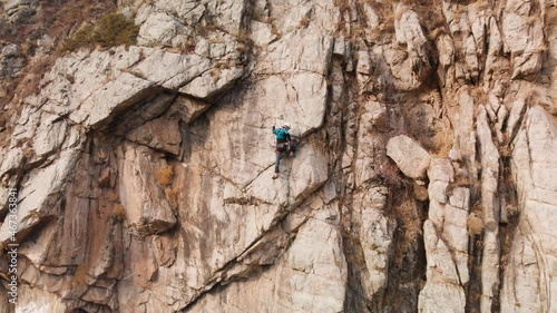 Man athlette climbing on the high rock