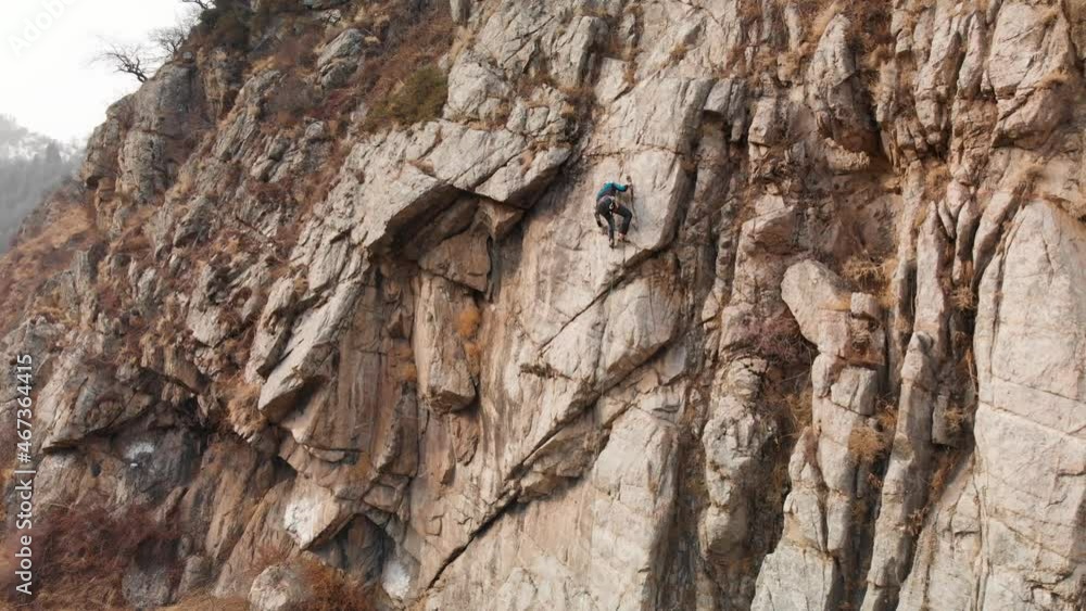 Man athlette climbing on the high rock Man athlette climbing on the high rock