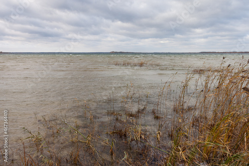 Lake in windy and cloudy weather. Autumn