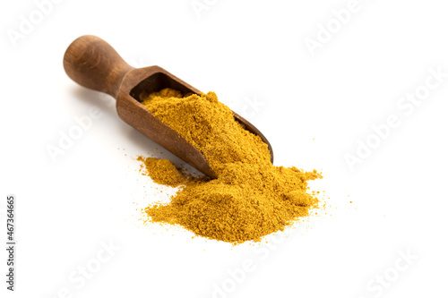 Valokuva Curry powder in wooden scoop isolated on white background