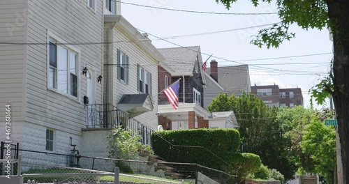 A 4K American flag waving in front of homes in the Bronx. New York, United States