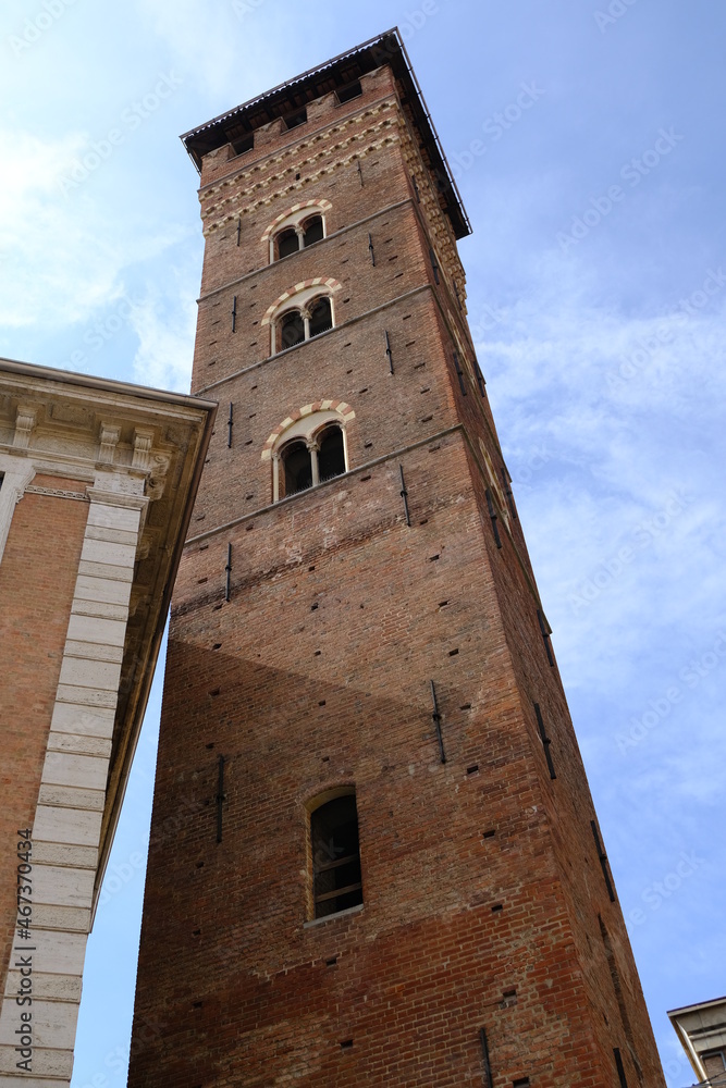Medieval tower. Trojan Tower of Asti.The tall tower, also known as the clock tower, is built in red terracotta bricks.  Asti, Piedmont, Italy.