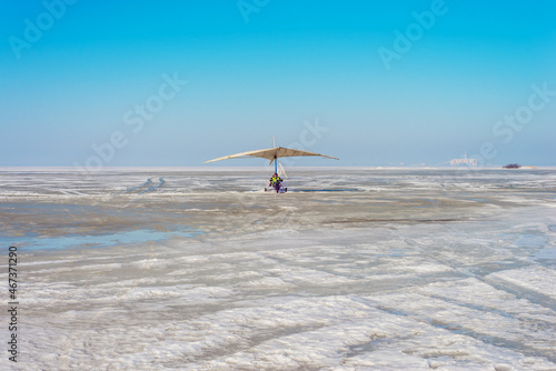 White sport hang glider on an ice field 