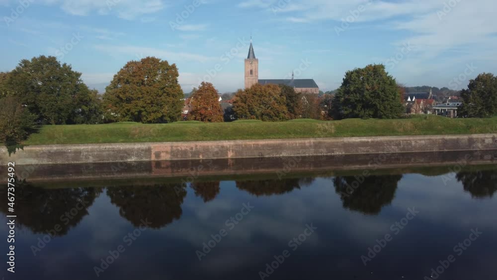 Fortress City Naarden Vesting in The Netherlands With Church and beautiful water reflections on a windless day, Aerial left and up Fortress City Naarden Vesting in The Netherlands With Church and beautiful water reflections on a windless day, Aerial left and up