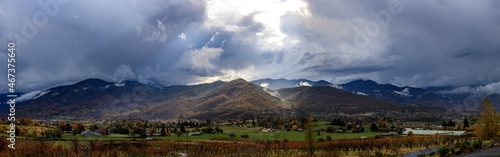 Giant panorama looking acorss a vineyard at the valley of Ashland Oregon with dramatic clouds and lighting