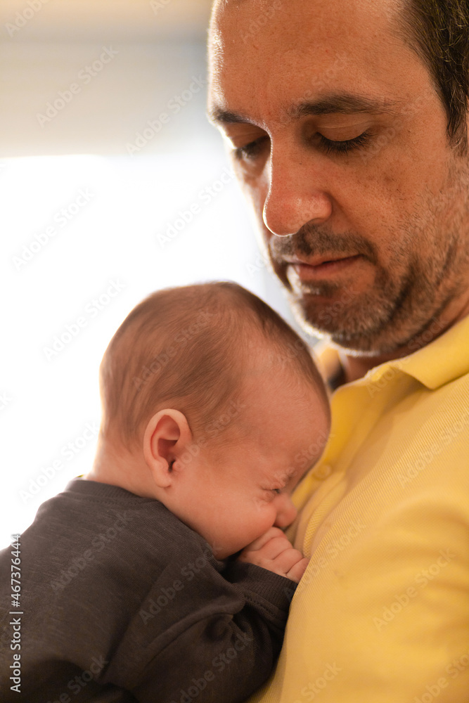 Calm dad embracing baby in daytime Calm dad embracing baby in daytime