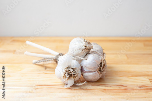 A bunch of garlic on a wooden table. Kitchen with natural products. Healthy healthy food. Spices. Live photo. Free space for text