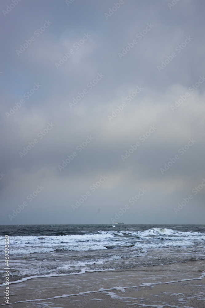 Northsea coast Julianadorp Netherlands. Beach. Clouds. Waves.