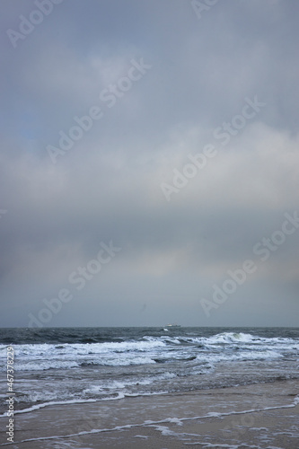 Northsea coast Julianadorp Netherlands. Beach. Clouds. Waves.