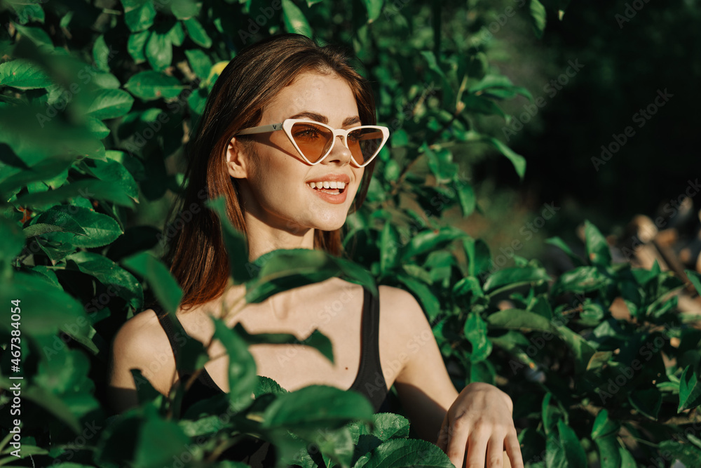 smiling woman wearing sunglasses green leaves nature fashion smiling woman wearing sunglasses green leaves nature fashion
