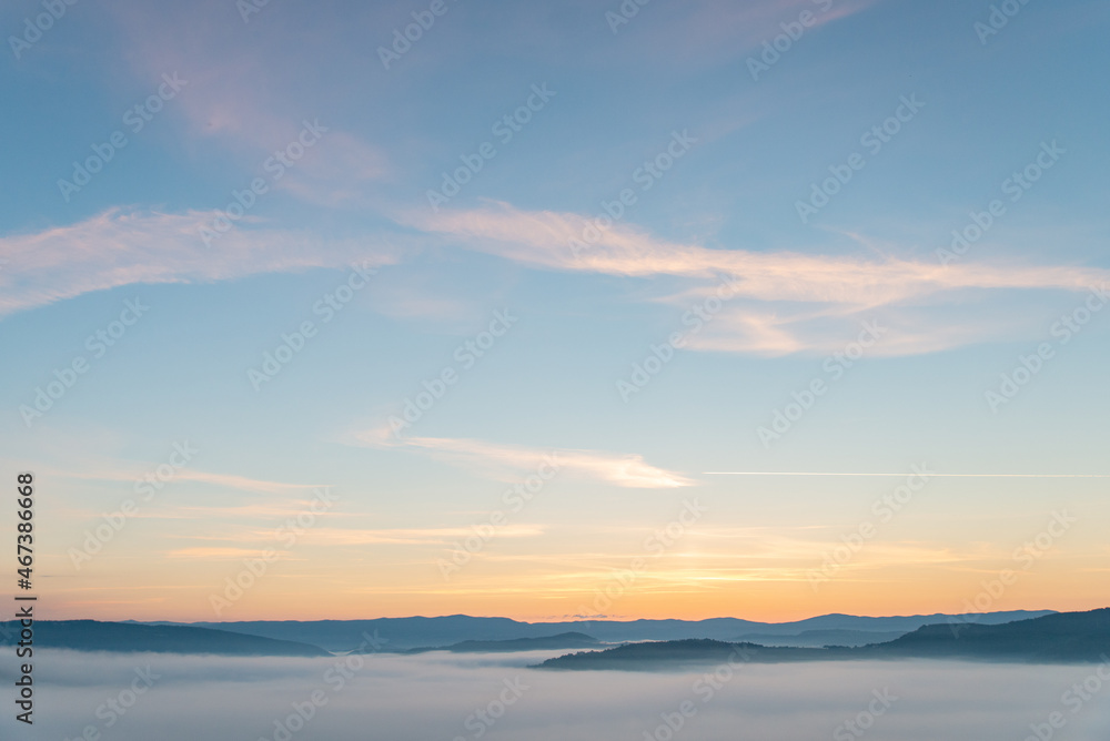 view of sunrise above mountains mist in the bottom view of sunrise above mountains mist in the bottom