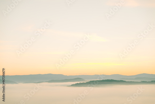 view of sunrise above mountains mist in the bottom