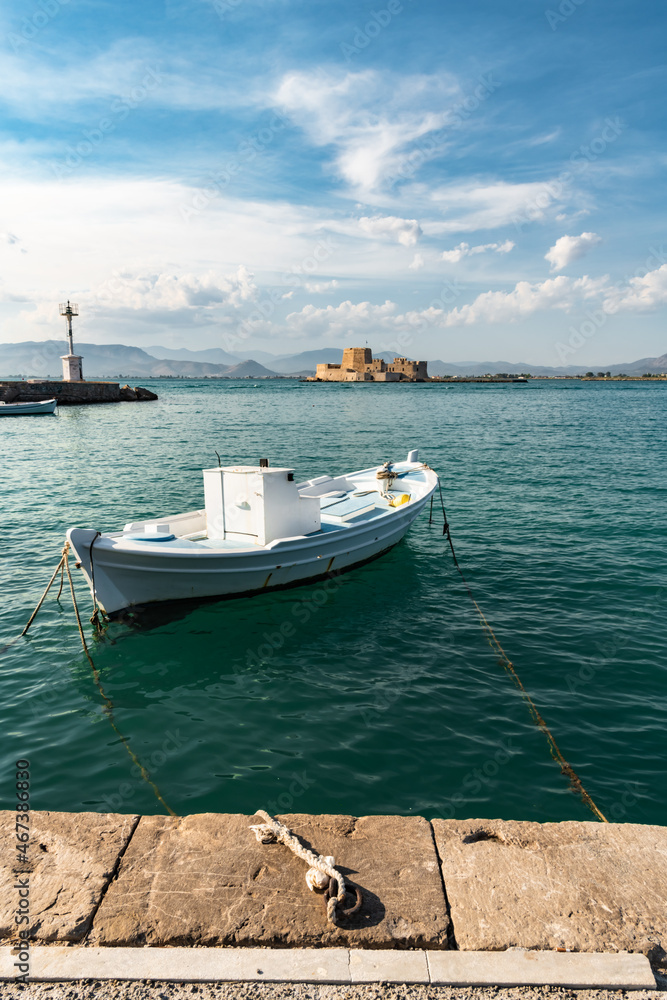 A fishing boat is moored to the embankment of Nafplion