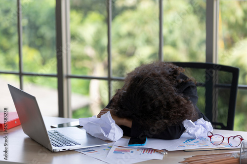 young business woman sleeping at the desk, working until tired