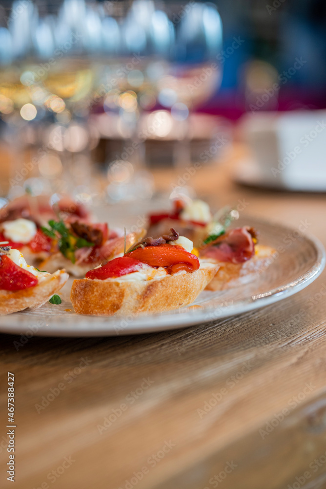 a dish of bruschetta sandwiches with vegetables on a plate in a restaurant a dish of bruschetta sandwiches with vegetables on a plate in a restaurant
