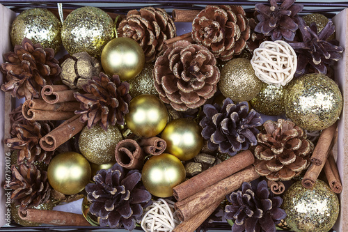 Christmas background of cones, Christmas balls, cinnamon. Flat composition, top view.