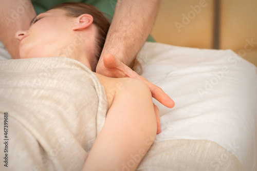 Young caucasian woman having a massage on the shoulder in spa salon