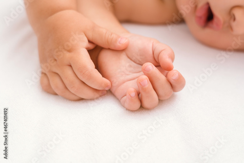 Hands of a sleeping baby close-up, selective focus on the palms of the child