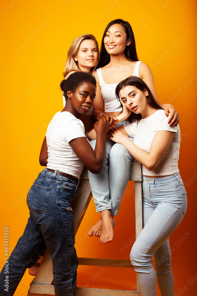 diverse multi nation girls group, teenage friends company cheerful having fun, happy smiling, cute posing on yellow background, lifestyle people concept, african-american, asian and caucasian diverse multi nation girls group, teenage friends company cheerful having fun, happy smiling, cute posing on yellow background, lifestyle people concept, african-american, asian and caucasian