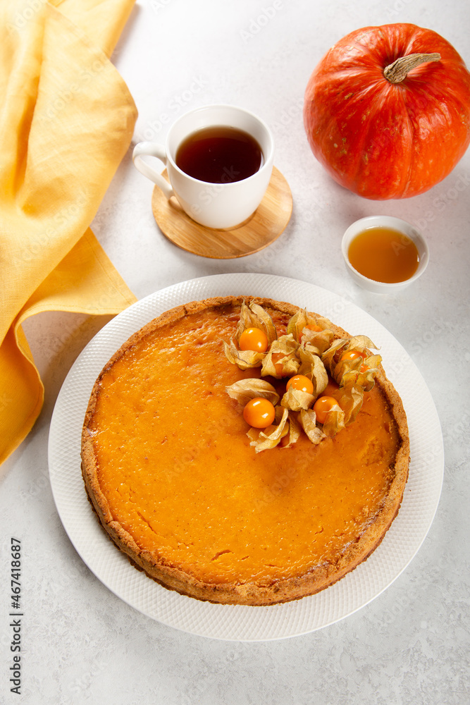 Homemade fresh orange pumpkin pie with physalis. Homemade fresh orange pumpkin pie with physalis.