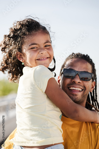 Dominican father and daughter smiling and loooking at camera