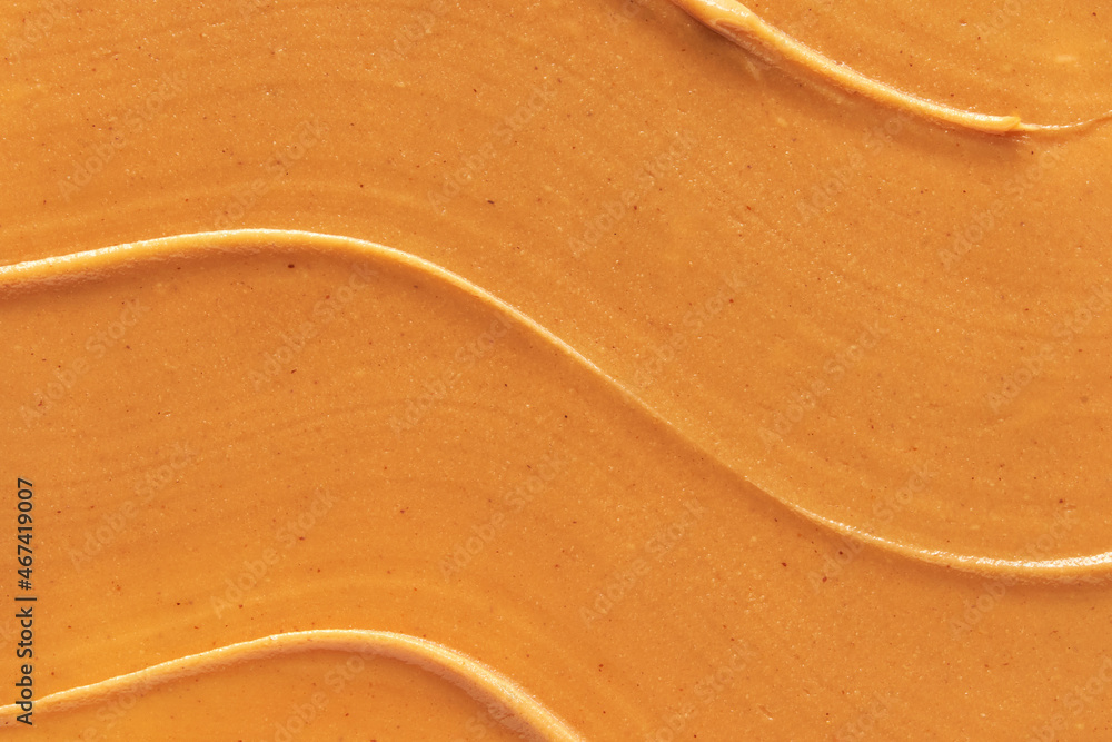 Obraz premium Peanut butter texture. Spread swirl. Organic keto food. Healthy creamy paste. Smooth closeup brown desert. Crunchy macro snack. Fat salt breakfast