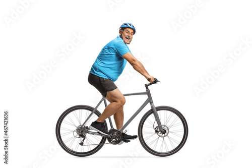 Happy mature male cyclist riding a road bike
