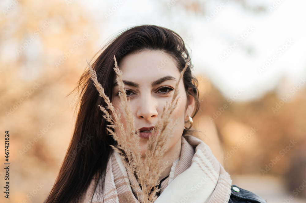 Portrait of a young woman in autumn in the park Portrait of a young woman in autumn in the park