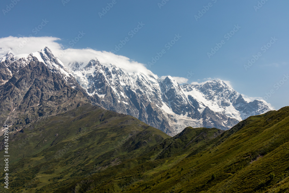A panoramic view on the snow-capped peak of Jangi-Tau(Dzhangi-Tau) in the Greater Caucasus Mountain Range in Georgia, Svaneti Region. Snowy and glaciated terrain. Mountaineering, freedom, wanderlust.